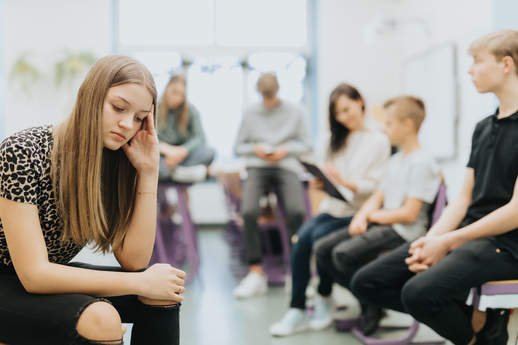 Teenage students sit in a circle during extra maths classes