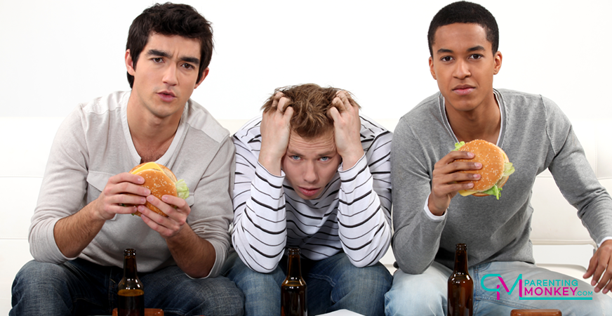 3 teen lads eating burgers